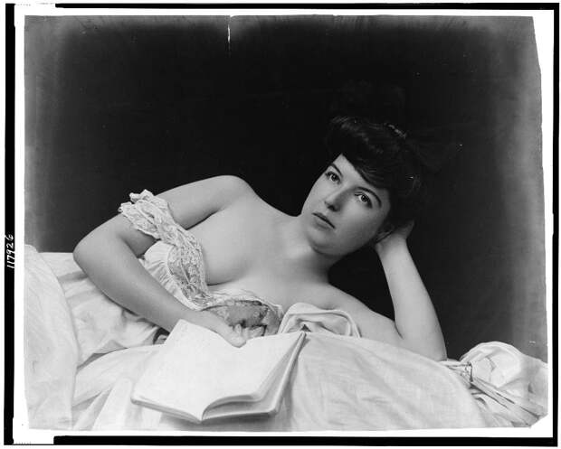 http://upload.wikimedia.org/wikipedia/commons/0/06/Young_woman,_wearing_negligee,_lying_in_bed,_holding_book.jpg