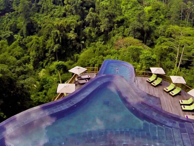 take-a-dip-in-one-of-the-multi-layered-infinity-pools-at-the-hanging-gardens-in-ubud-indonesia-while-being-surrounded-by-a-lush-and-tranquil-jungle