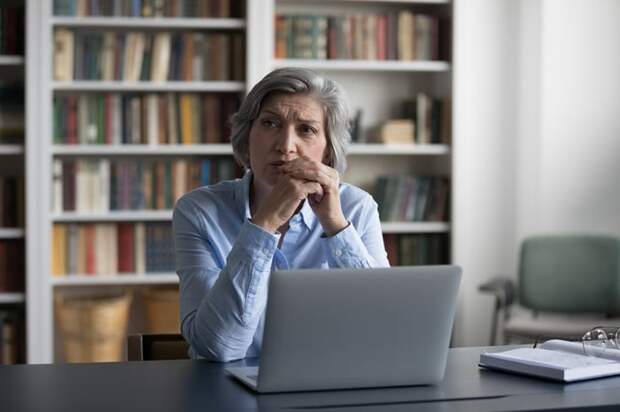 A person with a serious expression at a laptop.