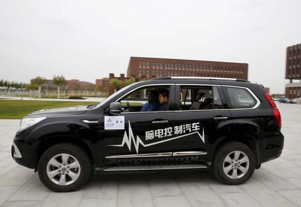 Researcher Zhang Zhao wearing a brain signal-reading equipment moves a car forward with his brain wave during a demonstration at Nankai University in Tianjin, China, November 17, 2015. REUTERS/Kim Kyung-Hoon