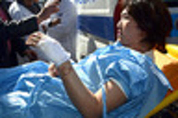 A victim arrives at the Charles Nicoles hospital, Wednesday, March 18, 2015 in Tunis, Tunisia. Authorities say scores of people are dead after an attack on a major museum in the Tunisian capital, and some of the gunmen may have escaped. (AP Photo/Edel Ezine)