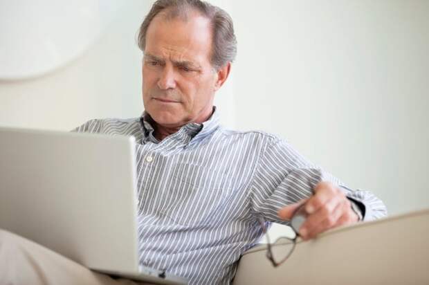 A person sitting with a laptop.