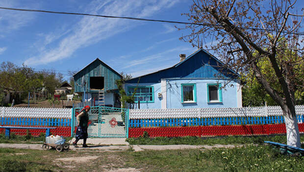 Жительница села Льговка Судакского района Крыма возвращается домой от уличной колонки, в которой нет воды. 2014 год