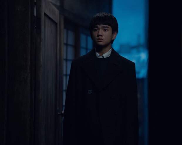 Noa stands in an open doorway