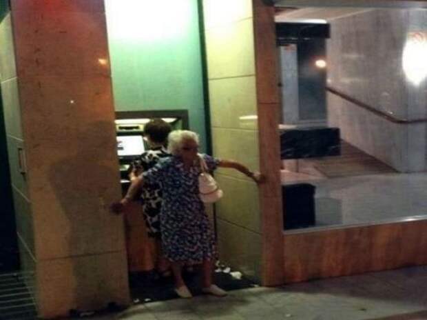 Grandmother Withdrawing Cash From Atm In Athens, Greece