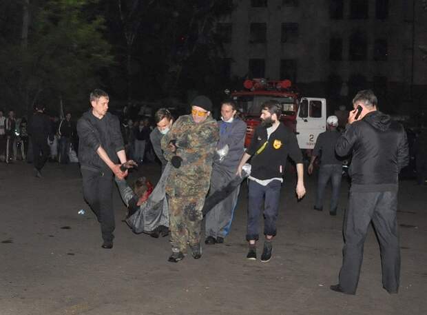 Люди выносят пострадавшего при пожаре в Доме профсоюзов, Одесса, 2 мая 2014 года