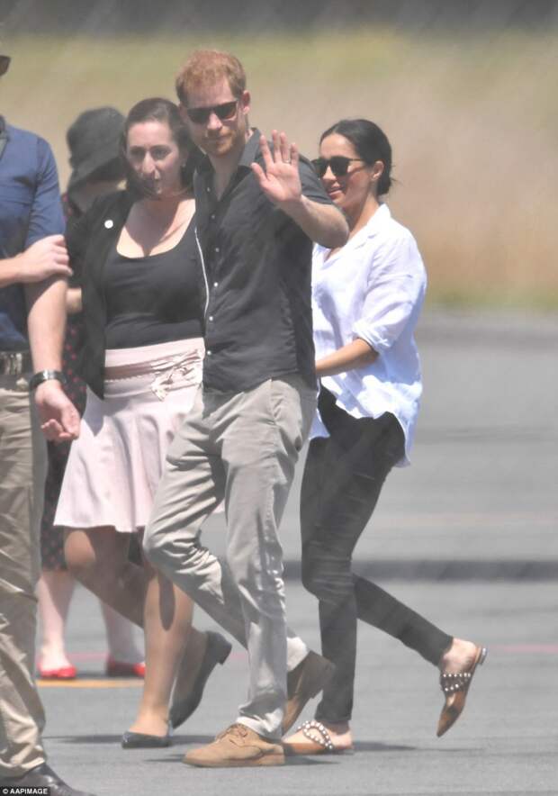 Prince Harry also gave a wave as he walked across the tarmac towards the awaiting Qantas aircraft which flew the royal couple to Fiji