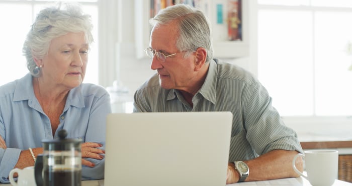 Two people at a laptop.