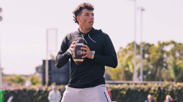 QB Dylan Raiola drops back for a pass during a training session.