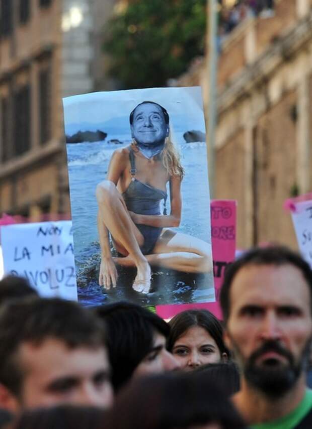 Demonstrators march holding a placard de