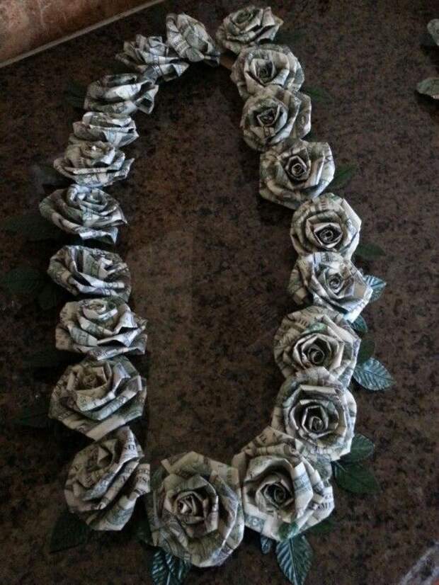 Dollar money origami graduation lei.  This is $100 in ones.  Each rose is 5 ones dollar bills.  The roses are made like the twisted crepe paper roses.