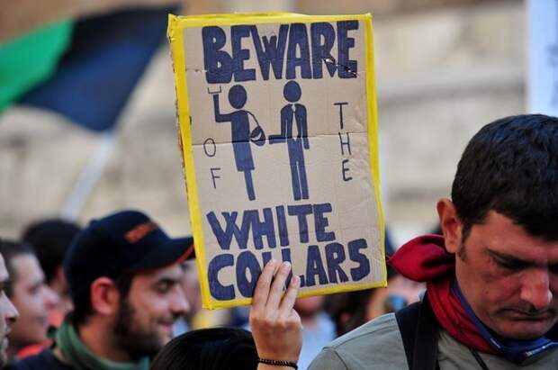 Demonstrators march brandishing placards