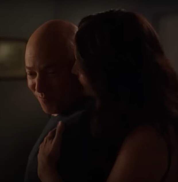 Evan Handler as Harry Goldenblatt smiles as he's hugged by his wife