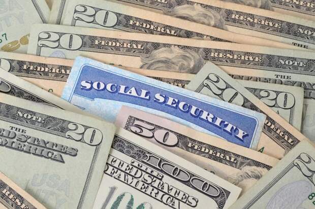Social Security card in a pile of money.