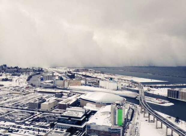 A band of storm clouds moves across Lake Erie and into Buffalo, N.Y., Tuesday, Nov. 18, 2014. Parts of New York measured the season's first big snowfall in feet, rather than inches, on Tuesday as 3 feet of lake-effect snow blanketed the Buffalo area and forced the closure of a 132-mile stretch of the state Thruway.