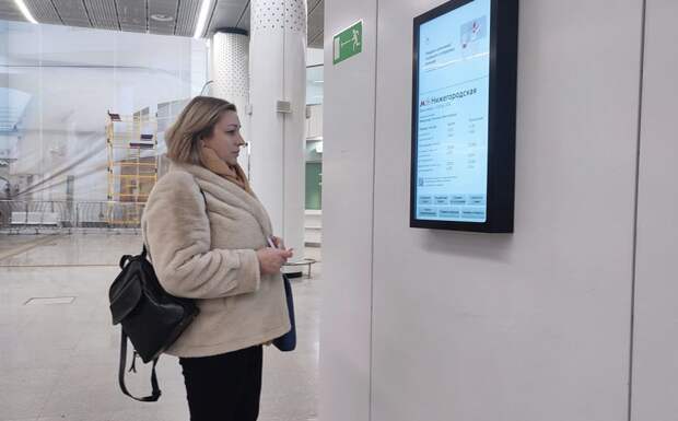 Пассажирка около нового интерактивного табло с информацией о работе московского транспорта. Фото: Михаил Подобед