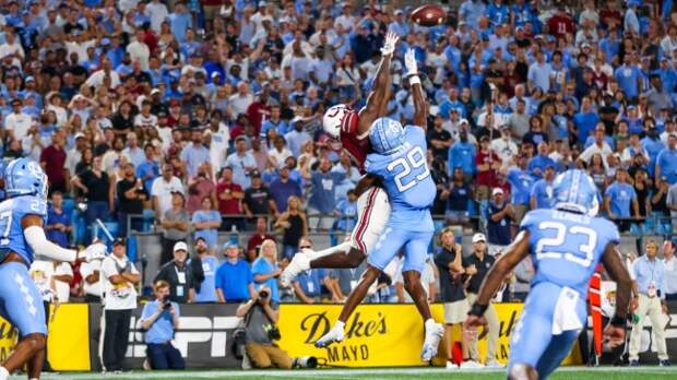 South Carolina WR Xavier Legette tries to catch a pass over a North Carolina defender.