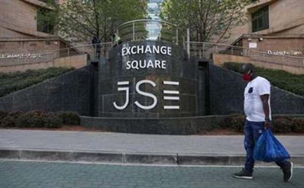 A man walks past the Johannesburg Stock Exchange (JSE), as the coronavirus disease (COVID-19) lockdown regulations are eased in Sandton, South Africa, September 10, 2020. REUTERS/Siphiwe Sibeko