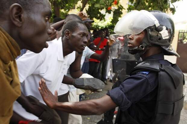 Protestors confront riot police outside the National Assembly during a demonstration in Senegal's capital Dakar