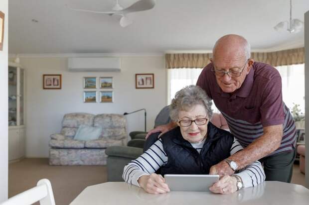 Couple looking at a tablet together.