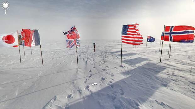 the-ceremonial-south-pole-is-a-metallic-sphere-on-a-pole-surrounded-by-the-flags-of-the-12-original-antarctic-treaty-signatory-states