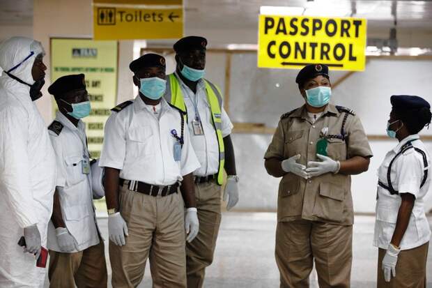 Health officials waited to screen passengers at the arrivals hall of Murtala Muhammed International Airport on Aug. 4 in Lagos, Nigeria.