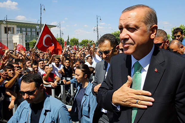 In this Friday, July 22, 2016 photo, Turkey's President Recep Tayyip Erdogan, acknowledges the crowd as he arrives at the parliament in Ankara, Turkey. Turkish lawmakers approved a three-month state of emergency that allows the government to extend detention times and issue decrees without parliamentary approval. (Press Presidency Press Service via AP, Pool)
