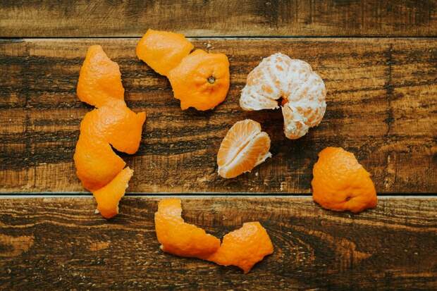 Peeled tangerine on a rustic wooden background