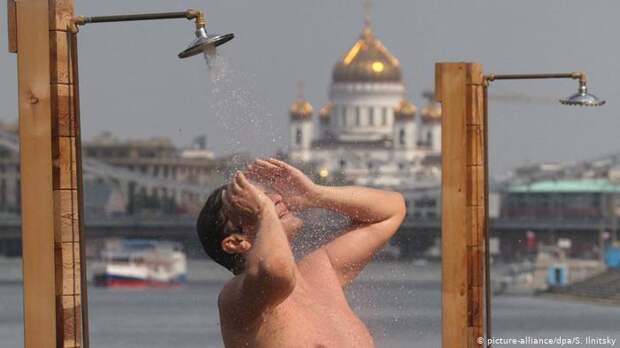 Летняя жара в Москве, мужчина принимает душ, на заднем плане храм Христа Спасителя