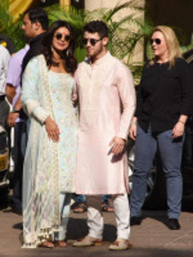 The happy couple recently began their wedding celebrations with a traditional Puja ceremony in Priyanka?s Mumbai home on Wednesday, 28th November. Both the Bride and Groom opted for traditional Indian outfits for the pre-wedding ceremony, honouring the Brides cultural roots. Nick wore a Pink Kurta while Priyanka stunned in a heavily embellished light blue suit. The couple were joined by family and friends including Nick?s brother Joe Jonas and his fiancee, Game of Thrones actress Sophie Turner. The couple will soon head to Jodhpur where they will continue the celebrations and are set to marry at the Umaid Bhawan Palace on Saturday, 2nd December, 2018. Pictured: Priyanka Chopra,Nick Jonas Ref: SPL5045354 281118 NON-EXCLUSIVE Picture by: SplashNews.com Splash News and Pictures Los Angeles: 310-821-2666 New York: 212-619-2666 London: 0207 644 7656 Milan: 02 4399 8577 photodesk@splashnews.com World Rights