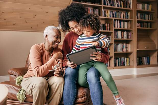 Three generations looking at an iPad.