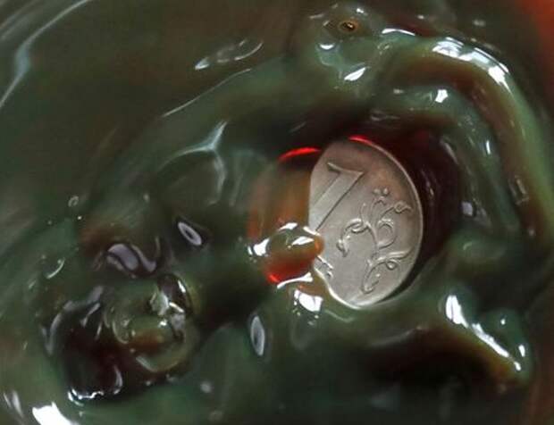 A view shows a one Russian rouble coin inside a bulb with crude oil at a laboratory in the Yarakta Oil Field, owned by Irkutsk Oil Company (INK), in Irkutsk Region, Russia in this picture illustration taken March 12, 2019. Picture taken March 12, 2019. REUTERS/Vasily Fedosenko/Illustration