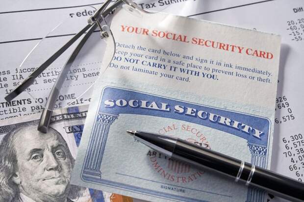 A Social Security card, a pen, and Ben Franklin.