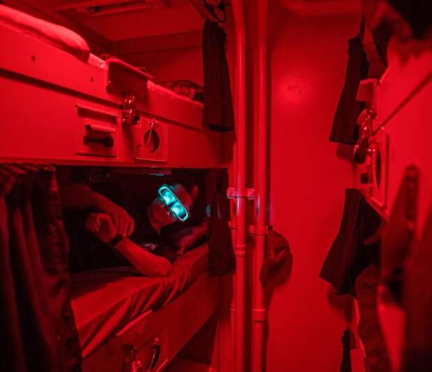 Resting in his bunk on the U.S.S. Paul Hamilton, a sailor wears light-emitting goggles for a short time after waking. When this photo was published in an August 2018 story about sleep, scientist Nita Shattuck was testing the goggles to see if they could reset sailors' internal clocks.