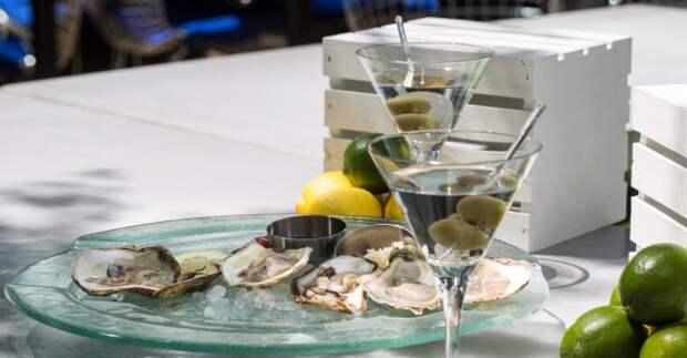 Fresh Oysters Served On Ice Accompanied By A Pair Of Dry Olive Martinis