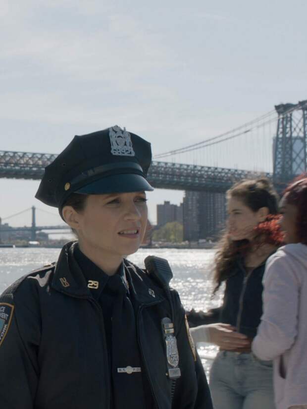 Eddie and Badillo in uniform standing in front of the bridge on Blue Bloods Season 14 Episode 13