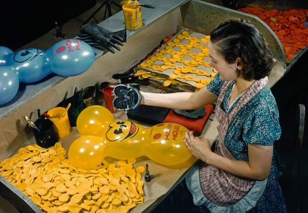 A story in the February 1940 issue documented the production of and many uses for rubber. Here, a factory worker in Ravenna, Ohio, stamps a Mickey Mouse face on balloons.