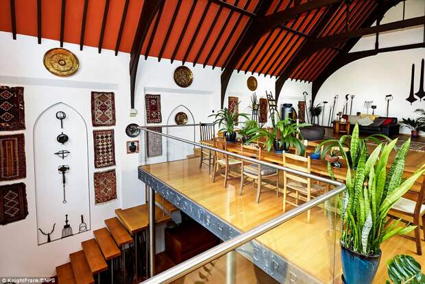 The open-plan dining room, kitchen and family area are across the roof terrace in the grander chapel section with the original beams. From here a staircase takes people down to the ground floor library, which has been partially opened up to enjoy the vaulted ceiling