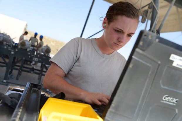 U.S. Air Force Airman 1st Class Casey Cain, a munitions systems technician currently assigned to the 455th Expeditionary Maintenance Squadron reviews technical order data before building a GBU-38 bomb. GBU-38s are part of the weapon system used on F-16C F
