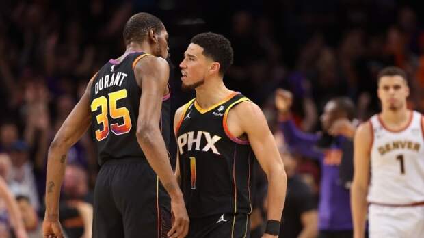 Devin Booker celebrates with Kevin Durant